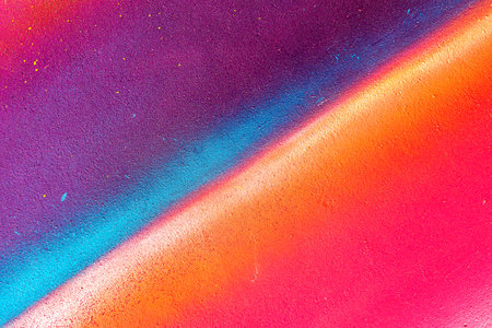 A fragment of colorful graffiti painted on a wall. Abstract urban background for design. spray painting art.の写真素材