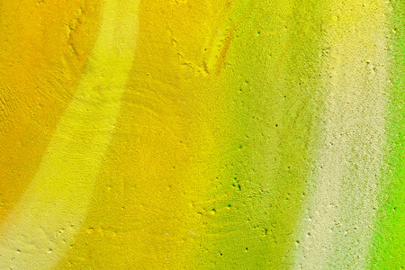 A fragment of colorful graffiti painted on a wall. Abstract urban background for design. spray painting art.の写真素材