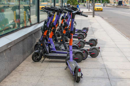 Moscow, Russia - JULY 16, 2022: Rental of electric scooters parked on the sidewalk.の写真素材