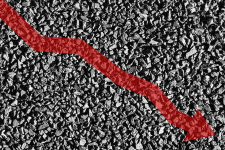 Arrow down on coal background. The concept of falling prices, mining, import, export, production, sales or supply of coal.の写真素材