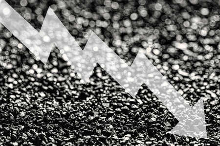 Arrow down on coal background. The concept of falling prices, mining, import, export, production,...