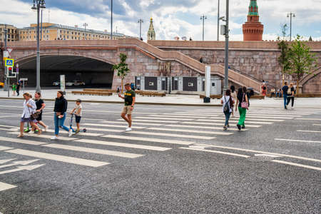 MOSCOW, RUSSIA, 17 JULY, 2022 : People crossing the asphalt road at the pedestrian crossing.の写真素材