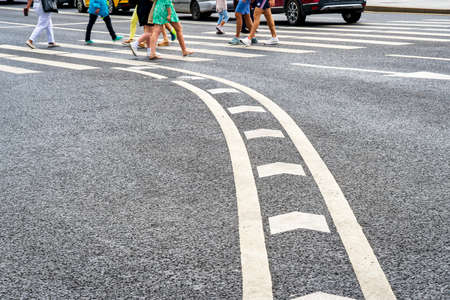 MOSCOW, RUSSIA, 17 JULY, 2022 : People crossing the asphalt road at the pedestrian crossing.の写真素材