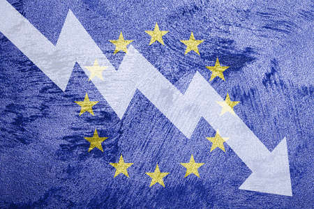 Arrow down on the background of the EU flag. The concept of economic recession, depression, crisis and the value of securities.の写真素材