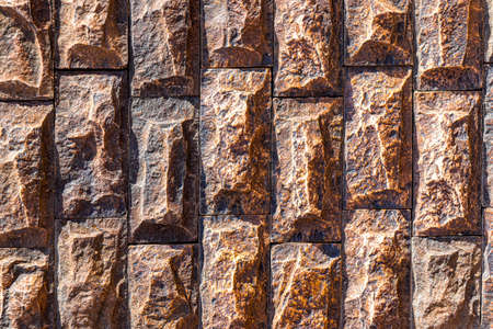 Texture of a wall covered with decorative brick-like tiles. Abstract background for design.