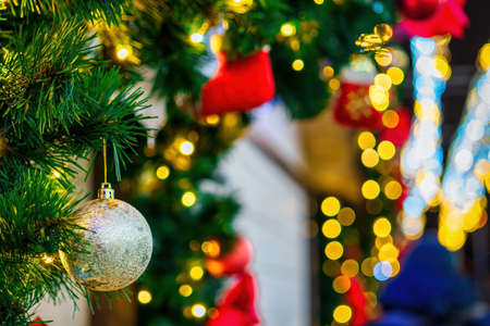 Christmas balls, toys and glowing garlands on an artificial spruce. Xmas abstract background.の写真素材