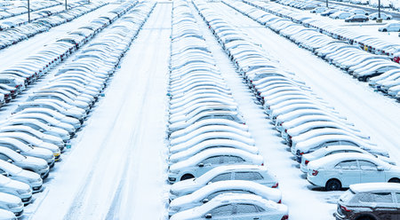 Volkswagen, Russia, Kaluga - NOVEMBER 11, 2022: New cars covered with a snow and parked in a distribution center, a car factory. Parking in the open air in winter.のeditorial素材
