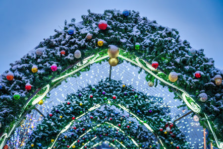 New Year or Christmas festive balls and garlands hanging in rows against the night sky background.の写真素材