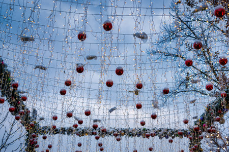 New Year or Christmas festive balls and garlands hanging in rows on twilight.の写真素材