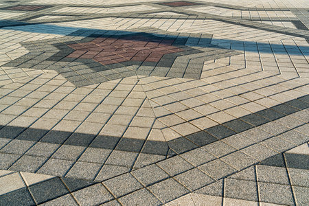 The texture of a stone old monotonous pavement with a perspective.の写真素材