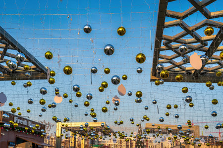 New Year or Christmas festive balls hanging in rows against the blue sky background.の写真素材