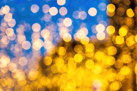 Blured festive garlands with glowing light bulbs against the background of the night sky. Holiday decorations.の写真素材