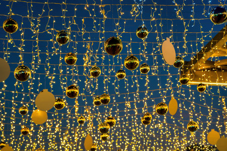 New Year or Christmas festive golden balls hanging in rows against the night sky background.の写真素材