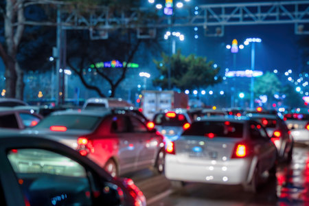 Uzbekistan, Tashkent - December 27, 2022: Car traffic lights at night city. Traffic jam in evening...