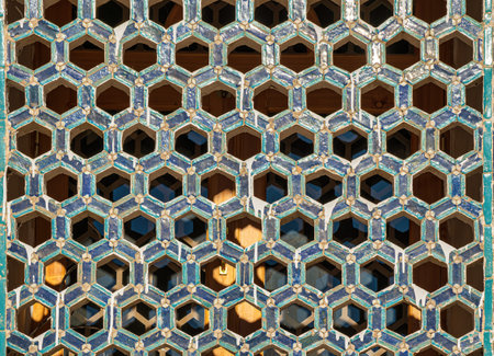 The window of a mosque Muslim behind bars in the form of a geometric hexagonal Islamic ornament. Abstract mosaic background.の写真素材