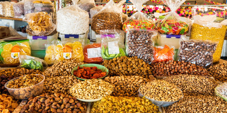 Oriental dried fruits and nuts on the counter of the bazaar. Asian market for nuts and dried fruits.の写真素材