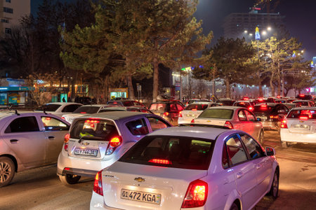 Uzbekistan, Tashkent - December 27, 2022: Car traffic lights at night city. Traffic jam in evening rush hour.のeditorial素材