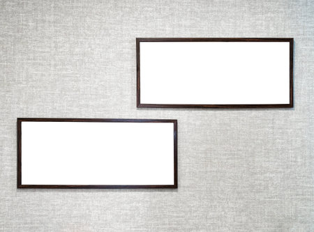 Two picture frames with copy space for text hanging on the wall with wallpaper. Mockup for design....