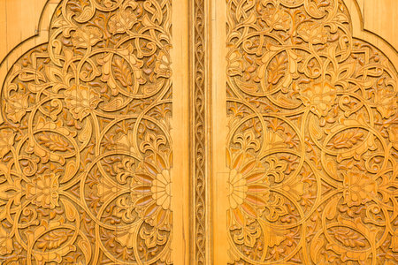 Carved antique wooden doors with patterns and mosaics.の写真素材