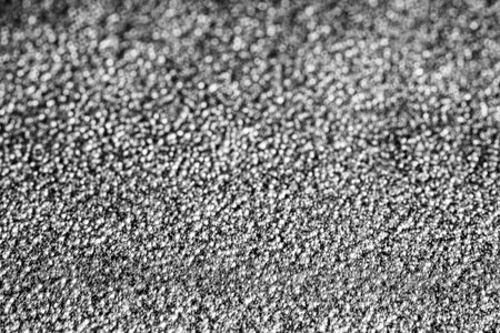 Monochrome texture of shiny grained metal. Abstract background for design.