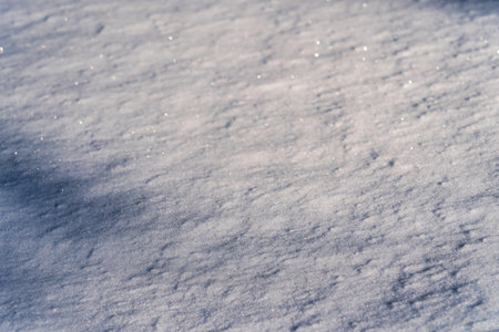Texture of snow illuminated by sunlight. winter background.