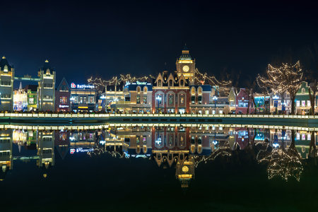 TASHKENT, UZBEKISTAN - DECEMBER 20, 2022: "Magic City" amusement park on a late evening reflected in a water.のeditorial素材