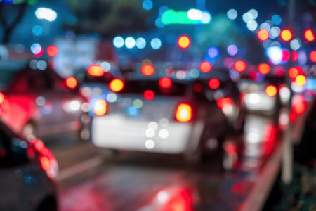 Blurred car traffic lights at night city. Traffic jam in evening rush hour.