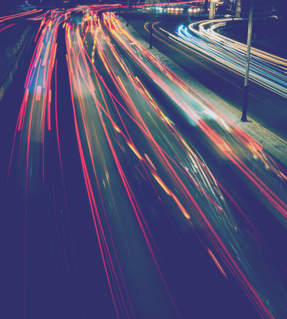 Car traffic light at night city highway.