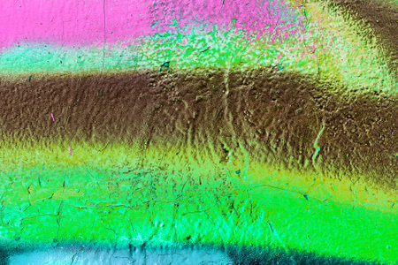 A fragment of colorful graffiti painted on a wall. Abstract urban background for design. spray painting art.の写真素材