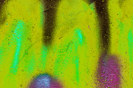 A fragment of colorful graffiti painted on a wall. Abstract urban background for design. spray painting art.の写真素材