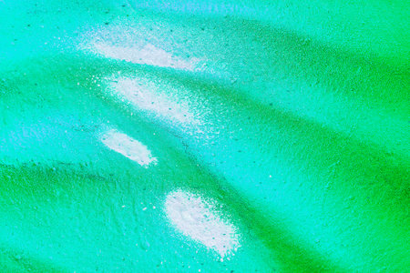 A fragment of colorful graffiti painted on a wall. Abstract urban background for design. spray...