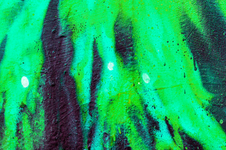 A fragment of colorful graffiti painted on a wall. Abstract urban background for design. spray painting art.の写真素材