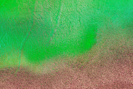 A fragment of colorful graffiti painted on a wall. Abstract urban background for design. spray painting art.の写真素材