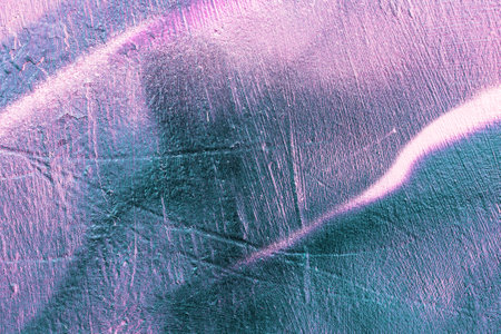 A fragment of colorful graffiti painted on a wall. Abstract urban background for design. spray painting art.の写真素材
