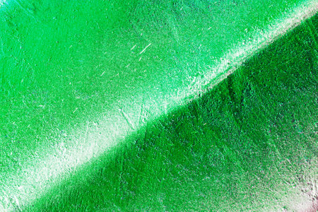 A fragment of colorful graffiti painted on a wall. Abstract urban background for design. spray painting art.の写真素材