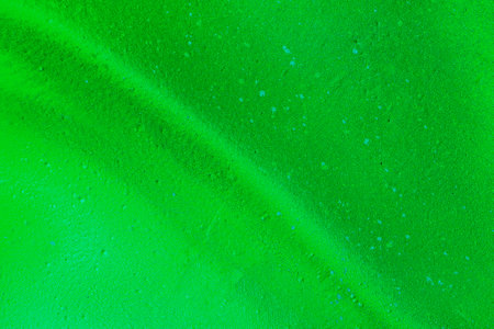 A fragment of colorful graffiti painted on a wall. Abstract urban background for design. spray painting art.の写真素材