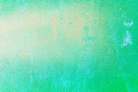 A fragment of colorful graffiti painted on a wall. Abstract urban background for design. spray...