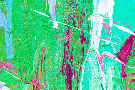 A fragment of colorful graffiti painted on a wall. Abstract urban background for design. spray...