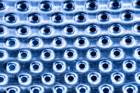 Texture of a stainless steel washing machine drum with holes.の写真素材