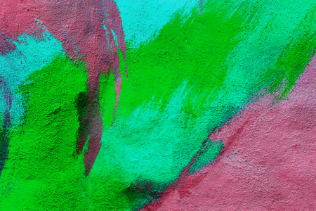 A fragment of colorful graffiti painted on a wall. Abstract urban background for design. spray painting art.の写真素材