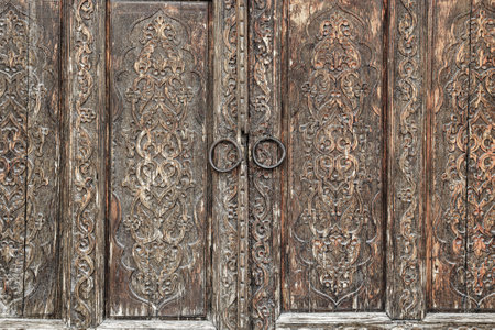 Carved antique wooden doors with patterns and mosaics. Abstract background for design.の写真素材