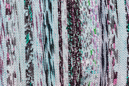 Texture of a multi-colored wicker floor carpet close-up. Abstract background for design.の写真素材