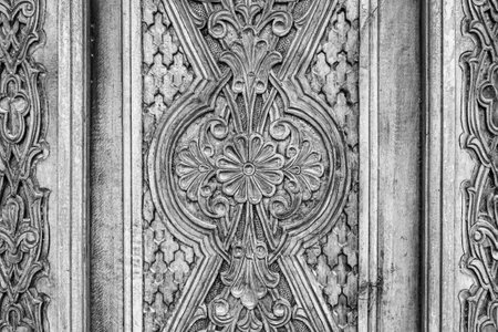 Carved antique wooden doors with patterns and mosaics.