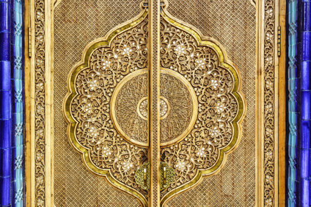 Carved antique wooden doors with patterns and mosaics.
