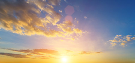 The rays of the sun breaking through the dramatic clouds in the evening or in the morning in the sunset or dawn sky. The concept of faith, hope for the best or good weather.の写真素材