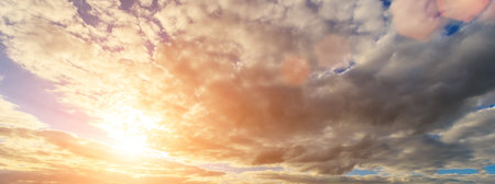 The rays of the sun breaking through the dramatic clouds in the evening or in the morning in the...