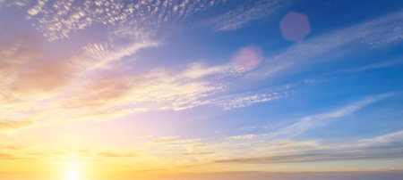 The rays of the sun breaking through the dramatic clouds in the evening or in the morning in the sunset or dawn sky. The concept of faith, hope for the best or good weather.の写真素材