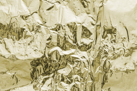 Texture of crumpled aluminum kitchen foil. Silver abstract blank for design.