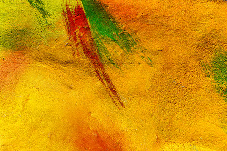 A fragment of colorful graffiti painted on a wall. Abstract urban background for design. spray...