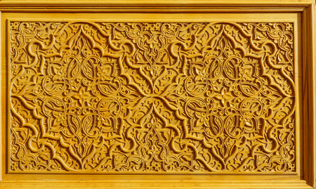 Fragment of a carved wooden door. Ornate background.